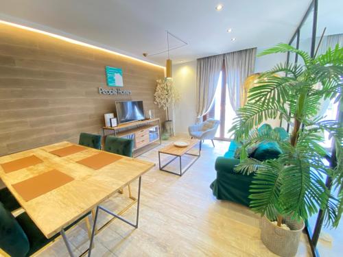 Una sala de estar con un sofá verde y una mesa. en People Homes Ponce 13, en Jerez de la Frontera