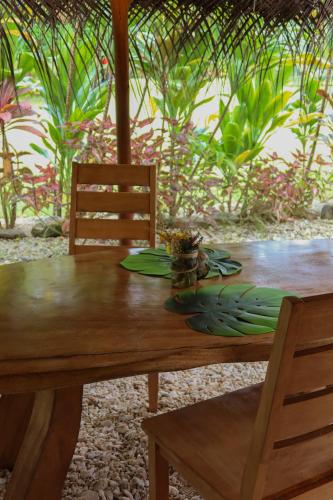 a wooden table with a plate of food on it at Fare Tearenui - Tu'i'anina Village Huahine in HUH