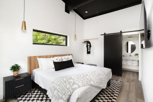 a bedroom with a large bed and a mirror at The Little Timber Cozy Hot Tub Fireplace in Townsend