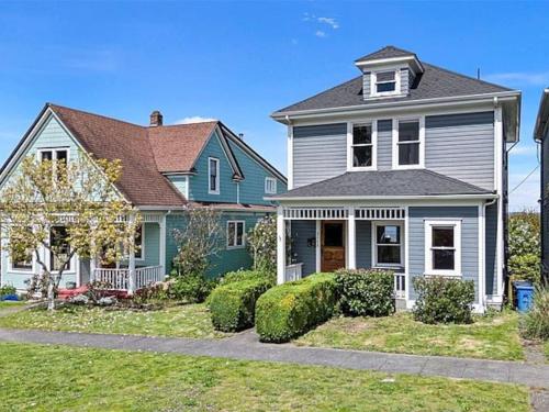 a house with a green and gray house at Bos Cozy Victorian Top Floor Duplex Unit with Puget Sound views in Tacoma