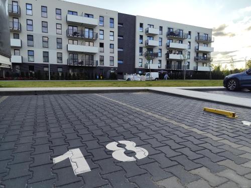 a parking lot with a number painted on it at Apartament dwupokojowy KASZMIR przy Onkologii z prywatnym miejscem parkingowym in Bydgoszcz