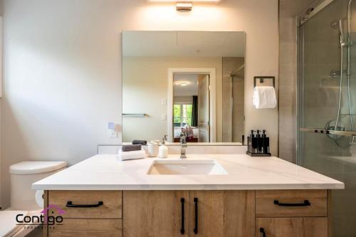 a bathroom with a sink and a mirror at Decked Out, Mtn Views, AC, Big Patio, DT, BBQ in Golden