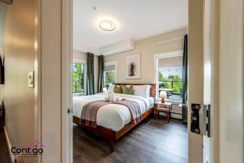 a bedroom with a bed and a large window at Decked Out, Mtn Views, AC, Big Patio, DT, BBQ in Golden