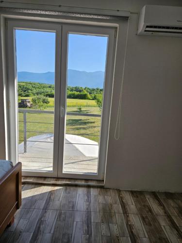 a room with sliding glass doors with a view at Villa Melek in Bihać