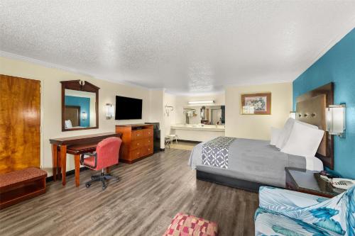 a hotel room with a bed and a desk at America's Best Value Inn and Suites in Aberdeen