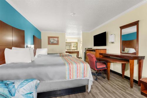 a hotel room with a bed and a desk at America's Best Value Inn and Suites in Aberdeen