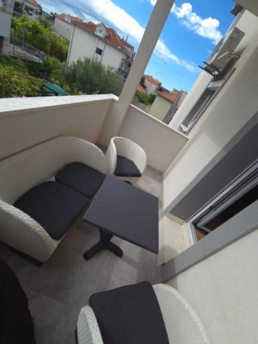 a view of a living room with a table and chairs at Apartman Ivana in Split