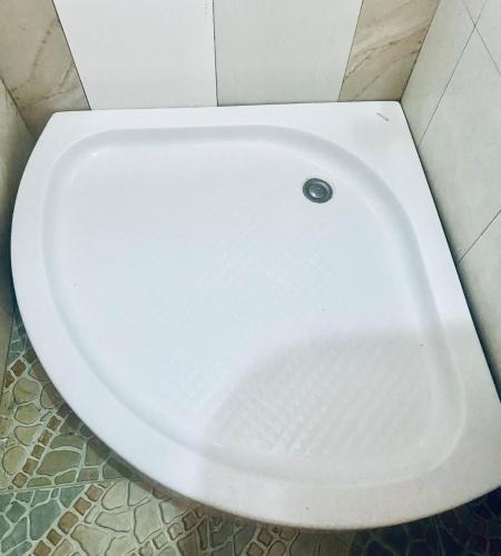 a white toilet bowl in a bathroom stall at Apart T 0 Studio or Flat Style in Downtown in Luanda
