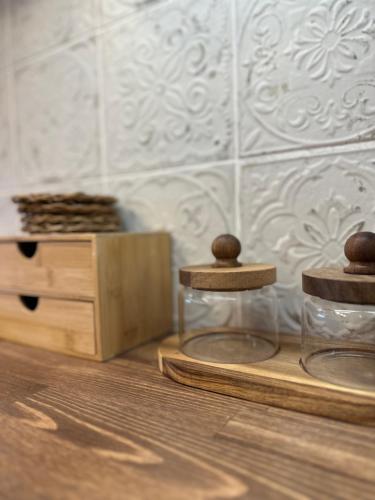 a table with two glass jars and a wooden box at Theros Retreat in Káspakas