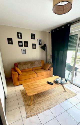 a living room with a couch and a coffee table at Elegant Studio in Libourne in Libourne
