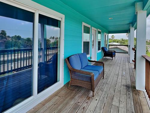 a porch with a couch and chairs on a deck at Pura Vida Oasis in Aransas Pass