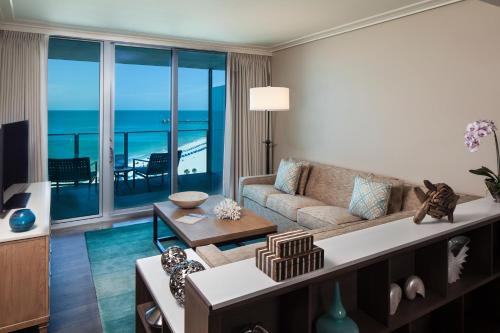 a living room with a couch and a view of the ocean at Opal Sands in Clearwater Beach