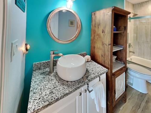 a bathroom with a sink and a mirror at Pura Vida Oasis in Aransas Pass