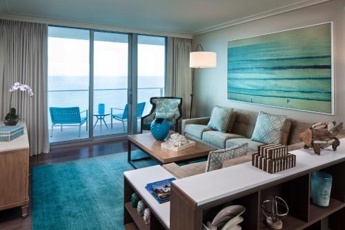 a living room with a couch and a table at Opal Sands in Clearwater Beach