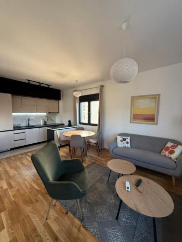 a living room with a couch and a table at Cozy 2BR apt in Podgorica