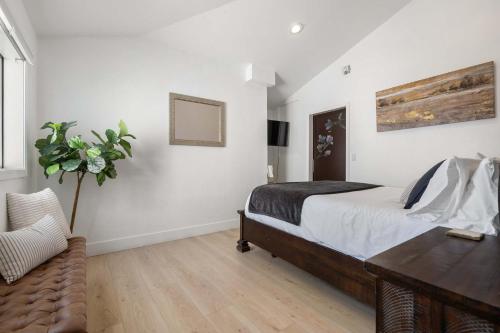 a bedroom with a bed and a table and a chair at Family Pool House with games in National City