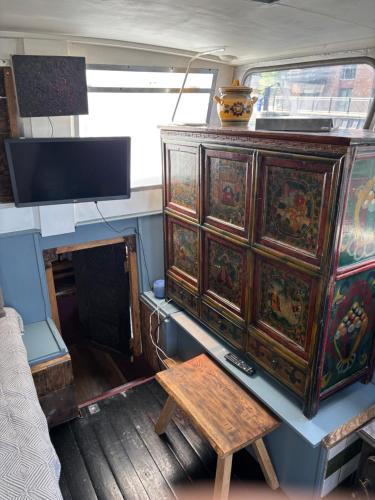 an old dresser with a wooden table in a room at Potato in London