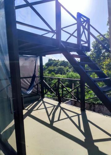 a canopy bed with a view of a forest at Pipa Universo in Pipa