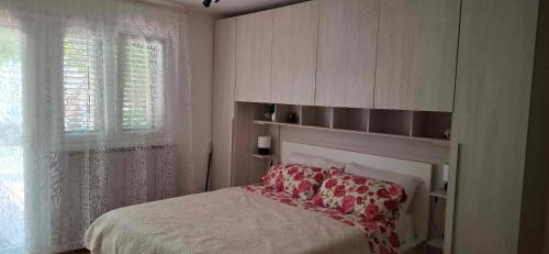 a bedroom with a bed and a window at Mike1890 in Portorož