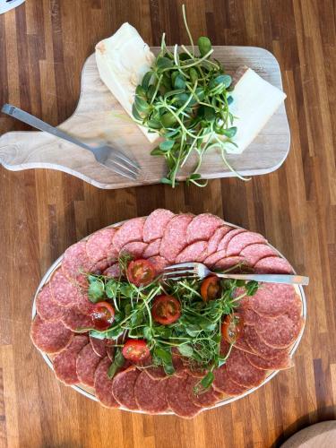 a plate of meat and vegetables on a table at Pensionat Næsgaarden in Allinge