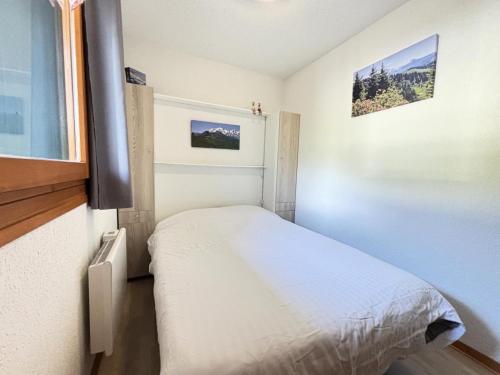 une petite chambre avec un lit et une fenêtre dans l'établissement Résidence Les Balcons Du Charvin - Appartement sud avec vue Mont-Charvin MAE-2724, à Notre-Dame-de-Bellecombe
