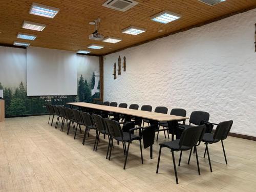 a conference room with a long table and chairs at Drevny Grad Park-hotel in Lviv