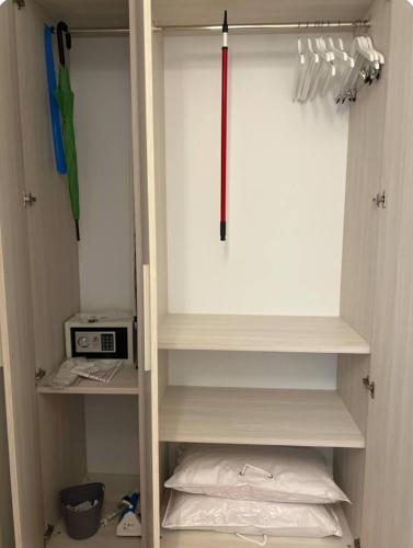 a cupboard with an umbrella and some utensils at Cecia's House in Bassano del Grappa