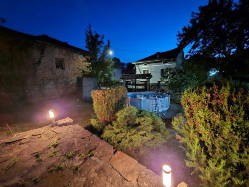 a backyard with a hot tub and two lights at Къща за гости Хитър Петър in Apriltsi
