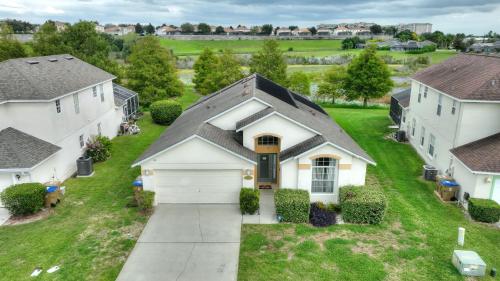 an aerial view of a house with a driveway at Star Oasis At Citrus Ridge By Shine Villas 091 in Orlando