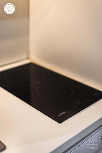 a black stove top oven sitting on top of a counter at Résidence Le Bois D'aurouze - Studio pour 4 Personnes MAE-8874 in Le Dévoluy