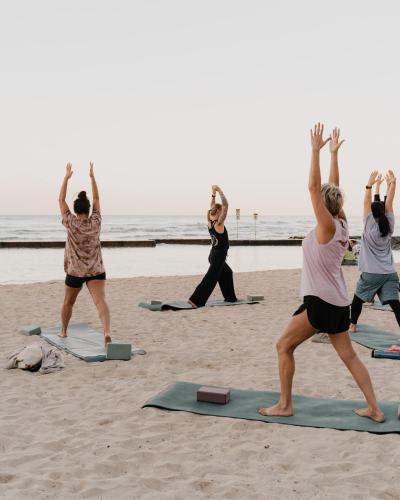a group of people doing yoga on the beach at Waikiki Resort Hotel in Honolulu
