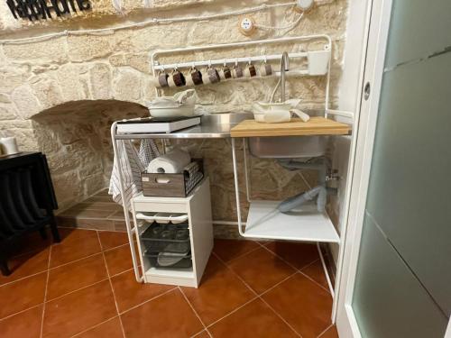 a small kitchen with a counter and a sink at La Grotta Paradiso in Molfetta