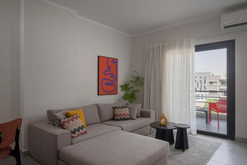 a living room with a couch and a table at Livingville East Aparthotel in Cairo