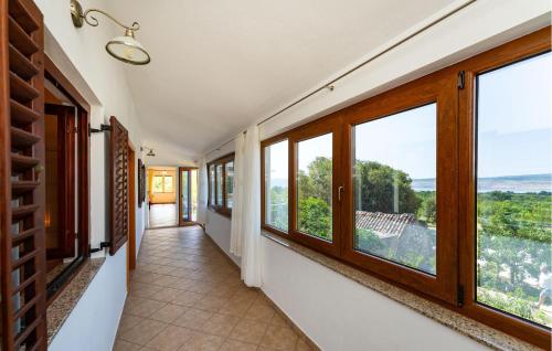 an empty hallway with windows and a view at 3 Bedroom Gorgeous Apartment In Seline in Seline