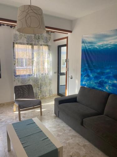 a living room with a couch and a chair at Estocolmo Lovely in Gran Tarajal