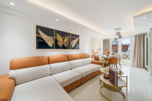 a living room with a couch and butterfly paintings at Prime Mayfair Luxury Stunning 2 Bedroom Apartment H12 in London