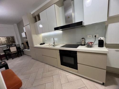 a kitchen with a sink and a stove top oven at Onis Apartment in Vlorë