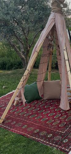 a teepee tent sitting on top of a rug at MOLA PAPAYA STUDIOS in Mola Kalyva