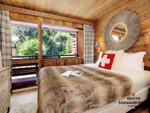 a bedroom with a large bed and a window at Résidence Solaret Des Brigues - Superbe duplex dans le quartier des Brigues MAE-5864 in Courchevel