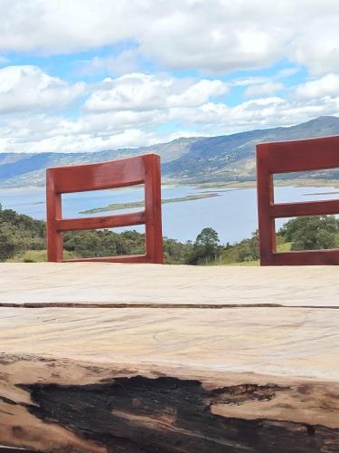 two red chairs sitting on top of a table at Casa Quinta Mozart in Guatavita