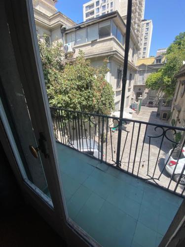 an open door to a balcony with a view of a street at BbCasita Blue in Santiago