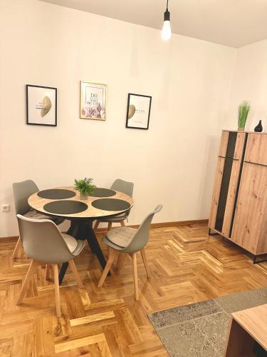 a dining room with a table and chairs at MonteRelax Apartments Becici in Rafailovici