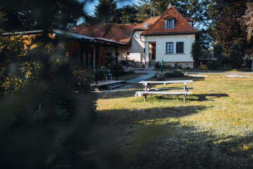 a picnic table in front of a house at Rekreační a školicí středisko Zájezek in Chlum u Třeboně