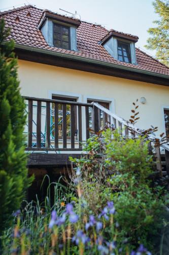 a house with a balcony and a roof at Rekreační a školicí středisko Zájezek in Chlum u Třeboně