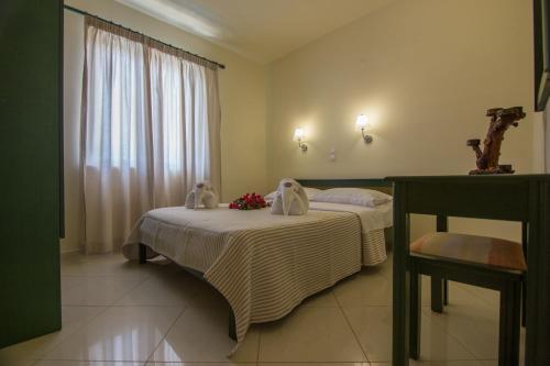 a bedroom with two beds and a window at Gianna Apartments in Almirida