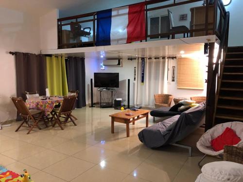 a living room with a loft bed and a dining room at Yangou Appart T4 in Mamoudzou