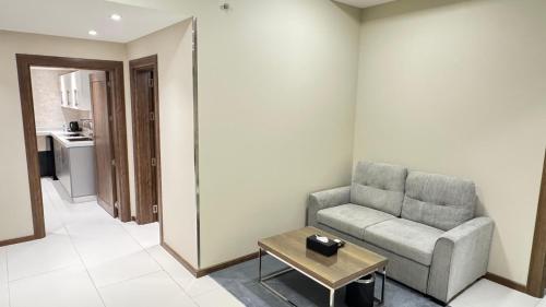 a living room with a couch and a coffee table at Golden Season Hotel - Al-Rass - فندق جولدن سيزون - الرس in Al Rass