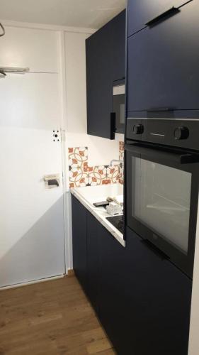 une cuisine avec une cuisinière et un comptoir dans l'établissement Résidence Zodiac - Studio pour 4 Personnes 954, à Aime La Plagne