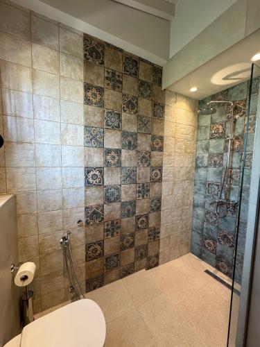 a bathroom with a shower with a toilet and a sink at Maresol in Nea Kalikratia