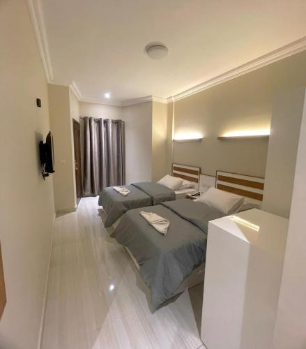 a bedroom with two beds and a television in it at Bright Moon in Dahab